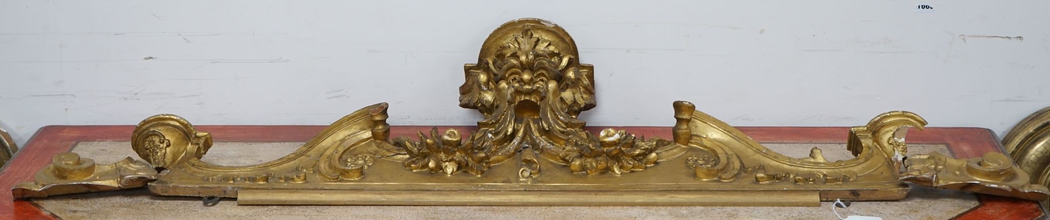 A 19th century carved giltwood pediment, width 142cm